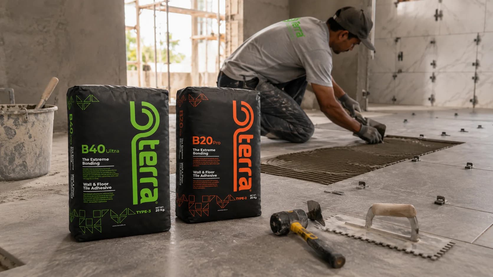 Tile installer applying adhesive at a construction site with Terra products nearby